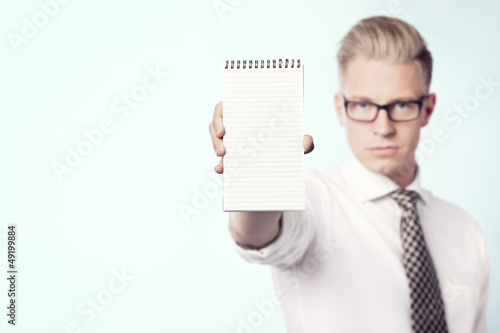 Photo: Businessman presenting blank notebook. Businessman presenting blank notebook.