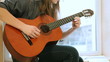 Teen Girl Playing Guitar At Home