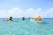 A group of surfers paddling aout to catch some waves