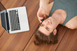 An attractive male talking on his cellphone whilst lying by his 