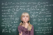 Photo: Schoolgirl at the Blackboard with Formulars Schoolgirl at the Blackboard with Formulars