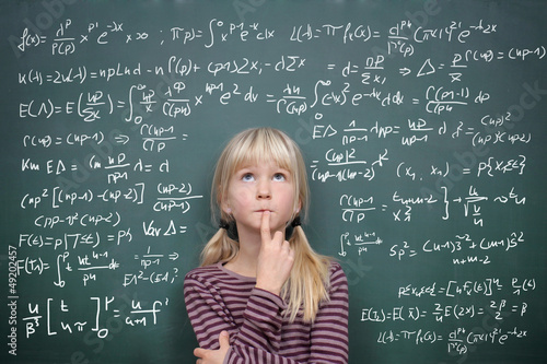 Photo: Schoolgirl at the Blackboard with Formulars Schoolgirl at the Blackboard with Formulars