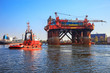 Photo: Oil rig in the company of a tug boats enters a port. Oil rig in the company of a tug boats enters a port.