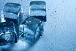 Ice cube and water drops on the wet background