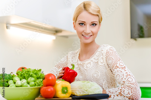 Photo: Young woman in the kitchen.Healthy Food. Dieting Concept. Young woman in the kitchen.Healthy Food. Dieting Concept.