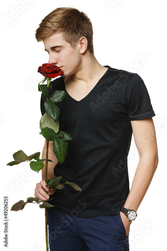 Photo: Young man smelling red rose with closed eyes Young man smelling red rose with closed eyes