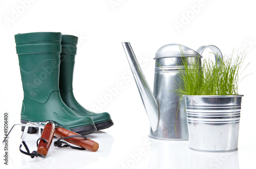 Photo: Garden tools and watering can with grass on white Garden tools and watering can with grass on white