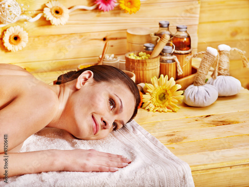 Photo: Woman getting herbal ball massage. Woman getting herbal ball massage.
