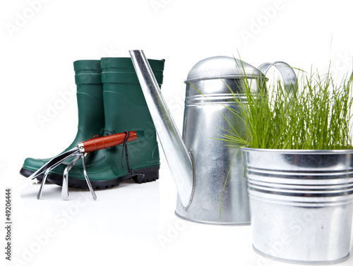 Photo: Garden tools and watering can with grass on white Garden tools and watering can with grass on white
