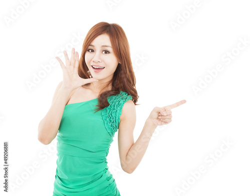 Photo: happy young woman shouting and pointing at something happy young woman shouting and pointing at something