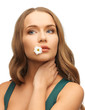 woman with camomile in mouth