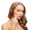 beautiful woman pointing to cheek