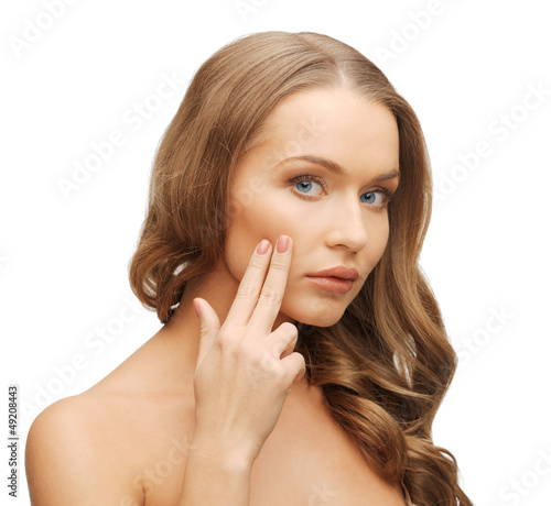 Photo: beautiful woman pointing to cheek beautiful woman pointing to cheek