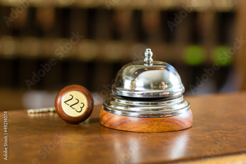 Photo: Reception - Hotel bell and key lying on the desk Reception - Hotel bell and key lying on the desk