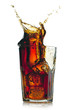 Splashing cola in glass. Isolated on white background