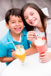 Kids drinking juice and smiling