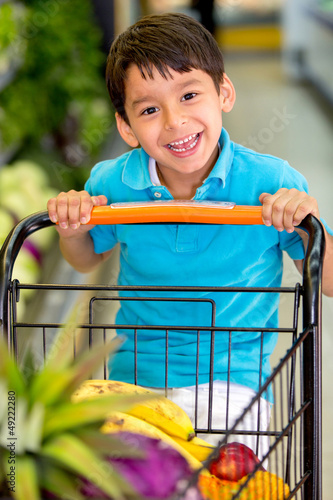 Photo: Boy playing with a shopping cart Boy playing with a shopping cart