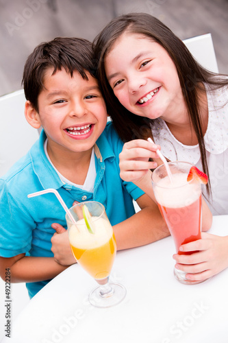 Photo: Kids drinking juice and smiling Kids drinking juice and smiling