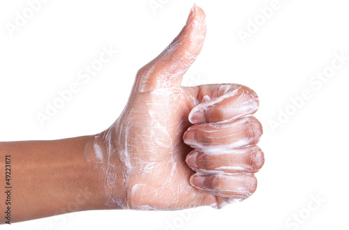Photo: Soapy African American womens hand making thumbs up Soapy African American womens hand making thumbs up