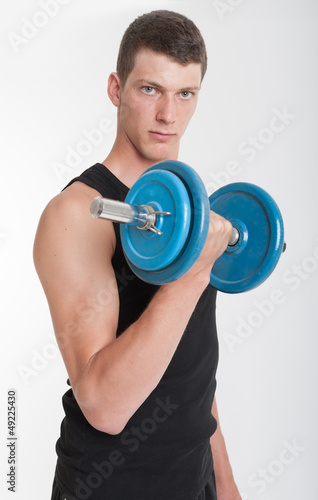 Photo: Young man with dumbbell Young man with dumbbell