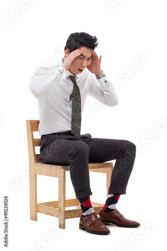 Photo: Young Asian man having a stress Young Asian man having a stress