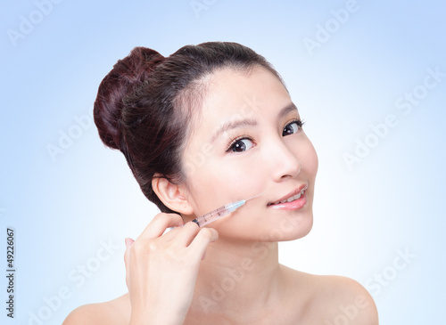 Photo: happy woman gets injection in lip happy woman gets injection in lip