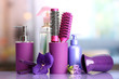 Hair brushes, hairdryer, straighteners and cosmetic bottles in