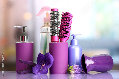 Photo: Hair brushes, hairdryer, straighteners and cosmetic bottles in Hair brushes, hairdryer, straighteners and cosmetic bottles in