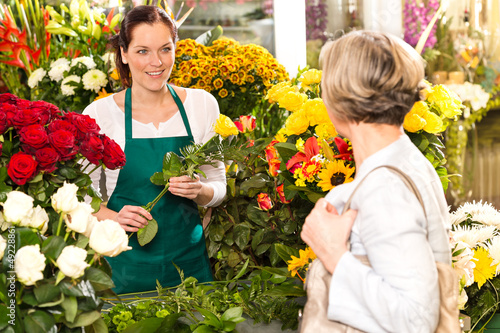 Photo: Young woman arranging flowers shop market selling Young woman arranging flowers shop market selling