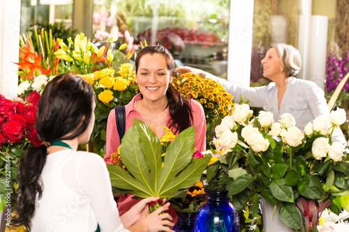 Photo: Young woman buying bouquet flower shop customer Young woman buying bouquet flower shop customer