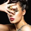 Beautiful woman with golden nails and style makeup