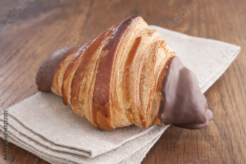 Photo: Chocolate croissant on rustic table Chocolate croissant on rustic table