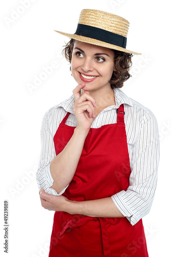 Photo: Smiling young thoughtful baker Smiling young thoughtful baker