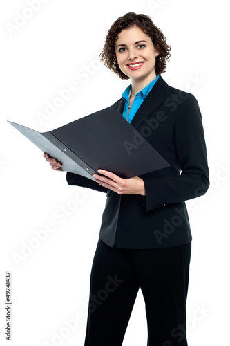 Photo: Businesswoman reviewing company documents Businesswoman reviewing company documents