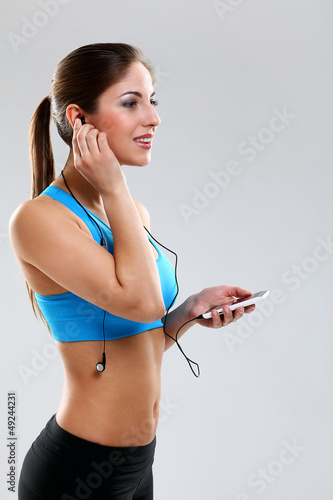 Photo: Young woman in fitness wear with headphones Young woman in fitness wear with headphones