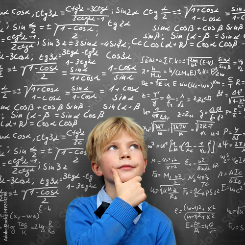 Photo: Schoolboy at the Blackboard with Formulas Schoolboy at the Blackboard with Formulas