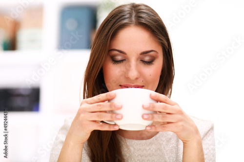 Photo: Young beautiful woman with cup Young beautiful woman with cup
