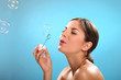 Natural caucasian woman with bubble blower
