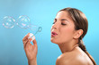 Natural caucasian woman with bubble blower