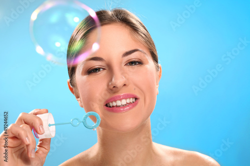 Photo: Natural caucasian woman with bubble blower Natural caucasian woman with bubble blower