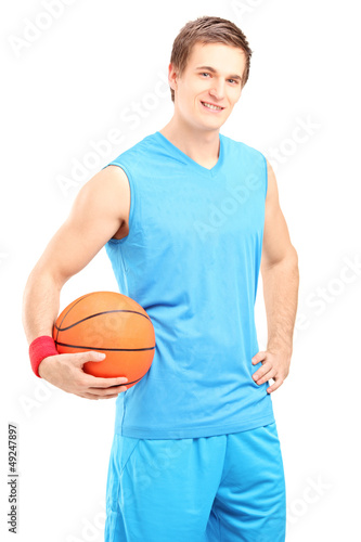 Photo: A smiling basketball player posing with a ball in his hand A smiling basketball player posing with a ball in his hand