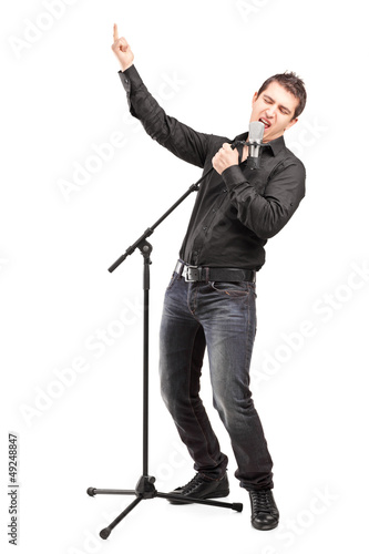 Photo: Full length portrait of a male singer performing a song Full length portrait of a male singer performing a song