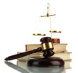 Golden scales of justice, gavel and books isolated on white