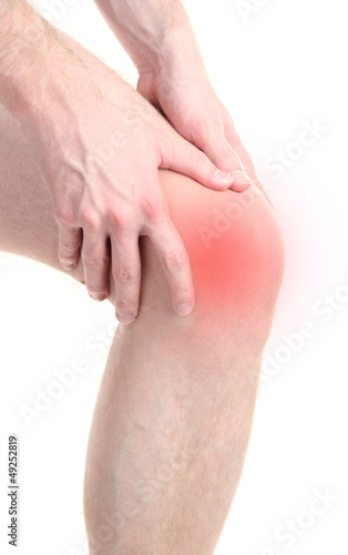 Photo: Man holding sore knee, isolated on white Man holding sore knee, isolated on white