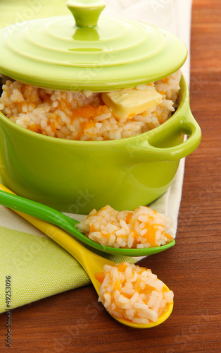 Photo: Taste rice porridge with pumpkin in saucepan Taste rice porridge with pumpkin in saucepan