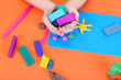 Child's hands holding plasticine over desk