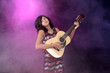 Child playing guitar on stage