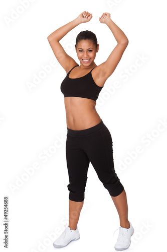 Photo: Portrait Of Excited Young Woman Jumping Portrait Of Excited Young Woman Jumping