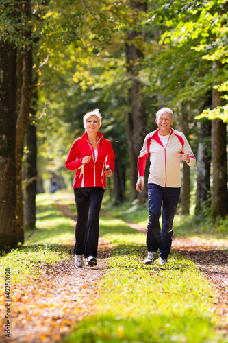 Photo: Seniors jogging on a forest road Seniors jogging on a forest road