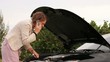 Woman having car trouble dolly left 2